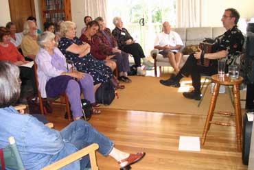 Brian Peters and audience at house party